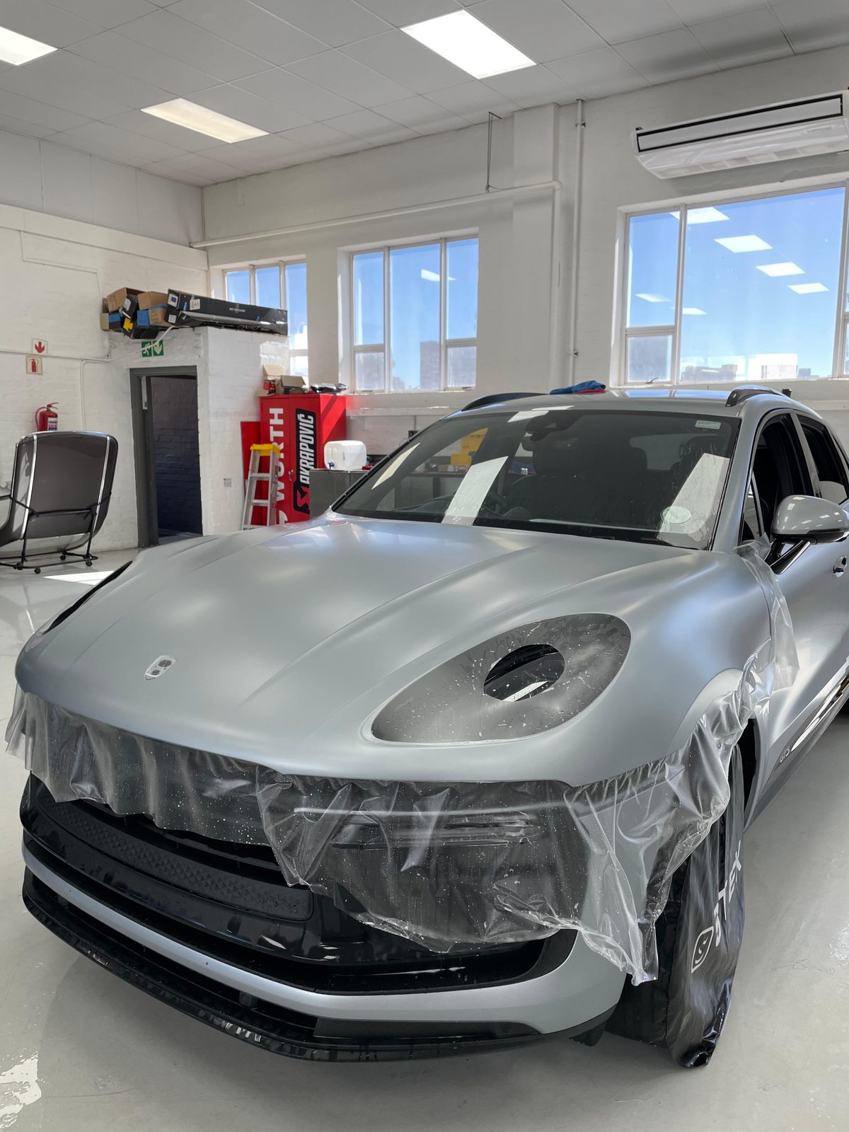 PPF film being applied to Porsche Cayenne by WrapAfrica